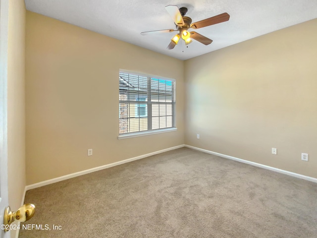 unfurnished room featuring ceiling fan and carpet floors