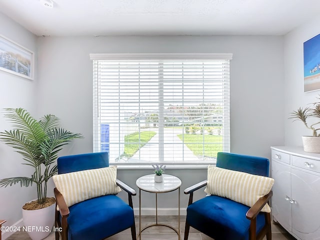 sitting room with tile patterned flooring and plenty of natural light