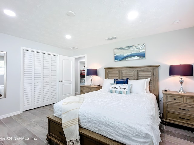 bedroom featuring light hardwood / wood-style flooring and a closet