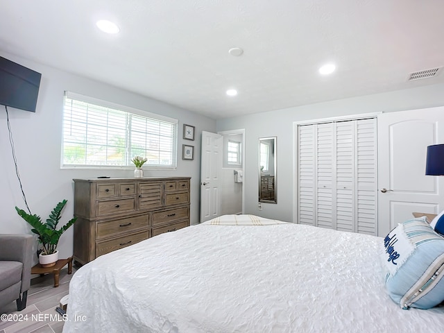 bedroom with hardwood / wood-style floors and a closet