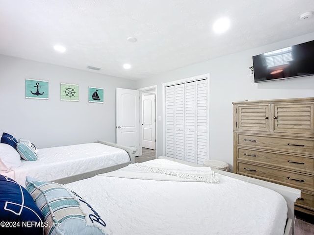 bedroom featuring hardwood / wood-style flooring and a closet