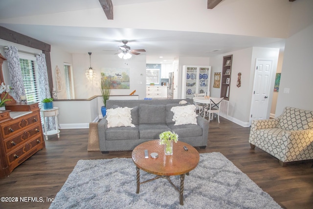 living room featuring lofted ceiling with beams, dark wood-style floors, baseboards, and a ceiling fan