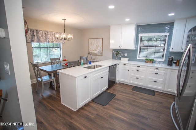 kitchen with a peninsula, light countertops, white cabinetry, and stainless steel appliances