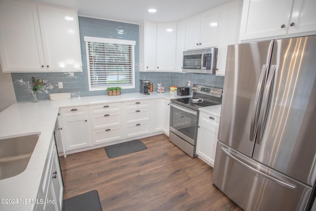 kitchen featuring dark wood-style floors, stainless steel appliances, backsplash, white cabinetry, and light stone countertops