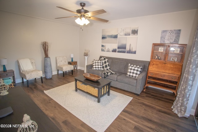 living room with dark wood-style floors, ceiling fan, and baseboards