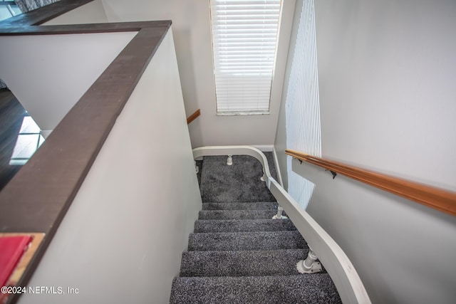 staircase featuring baseboards