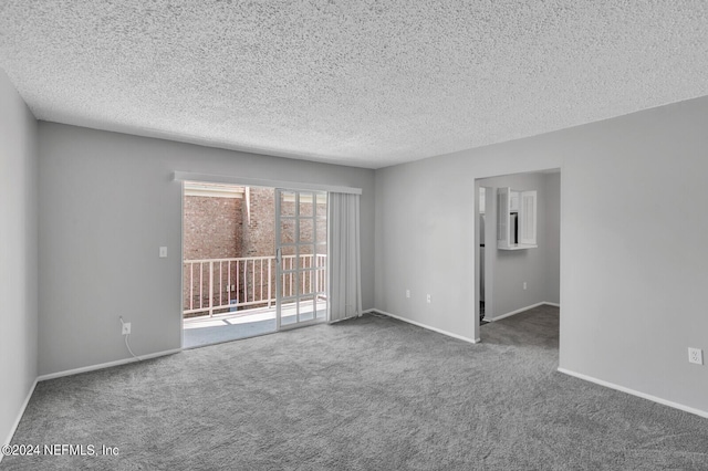 carpeted empty room with a textured ceiling