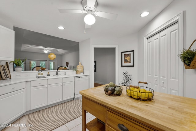 kitchen with ceiling fan, dishwasher, white cabinetry, and light tile floors