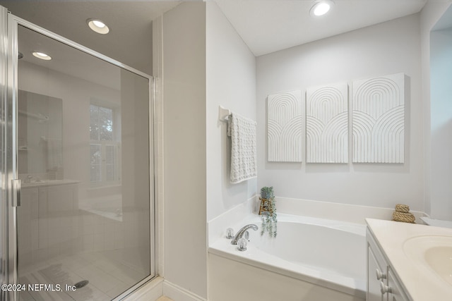 bathroom with vanity and plus walk in shower