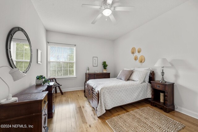 bedroom with ceiling fan and light hardwood / wood-style flooring