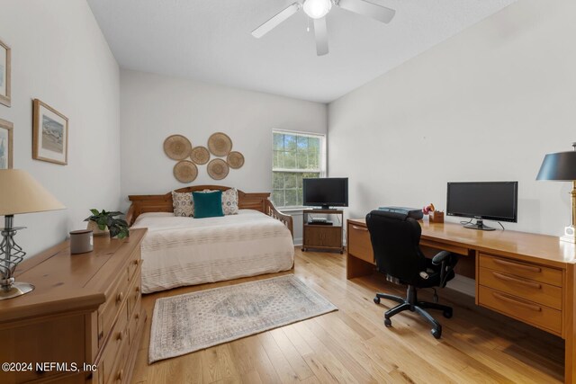 bedroom with ceiling fan and light hardwood / wood-style flooring