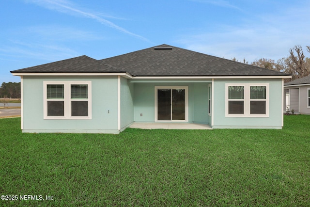 back of house featuring a shingled roof and a lawn