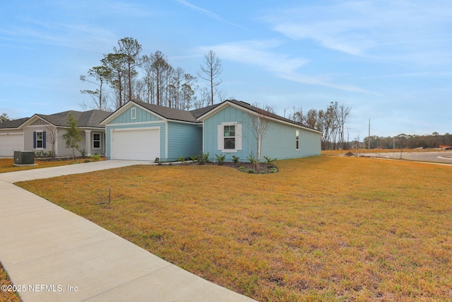 ranch-style house with a garage, driveway, board and batten siding, and a front yard