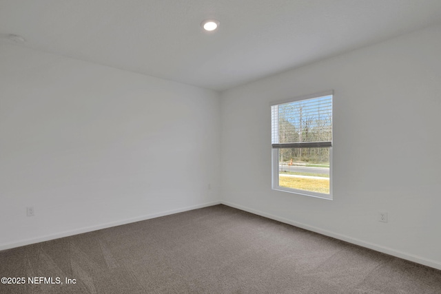 carpeted empty room featuring recessed lighting and baseboards