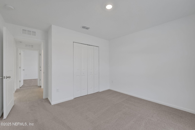 unfurnished bedroom with visible vents and carpet flooring