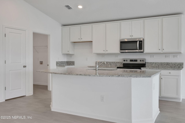 kitchen featuring visible vents, appliances with stainless steel finishes, a sink, and white cabinetry