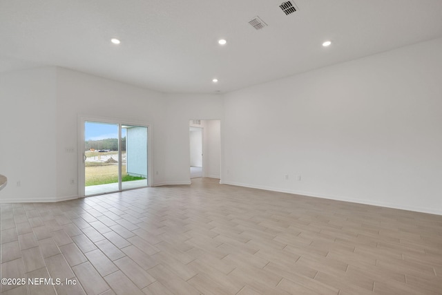 empty room with baseboards, light wood finished floors, visible vents, and recessed lighting