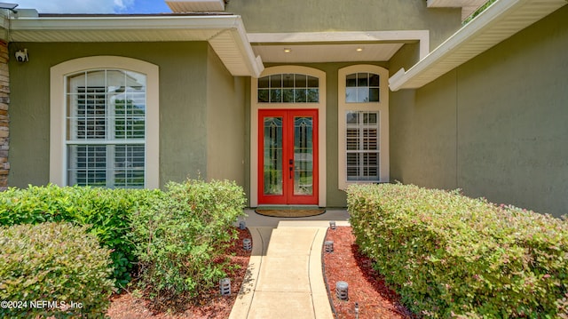 view of exterior entry featuring french doors