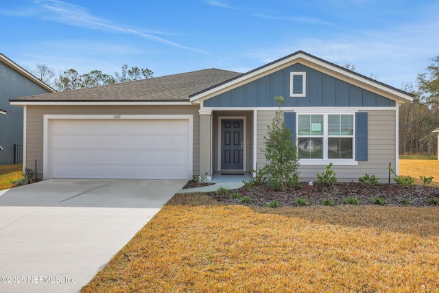 view of front of home featuring board and batten siding, a front yard, roof with shingles, a garage, and driveway