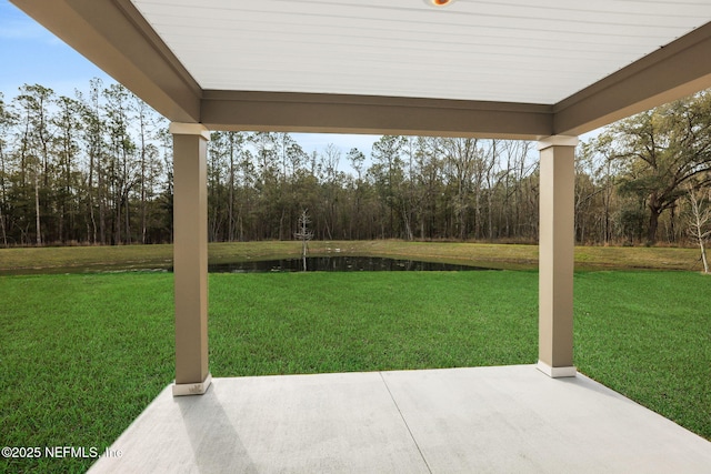 view of yard with a patio area and a water view