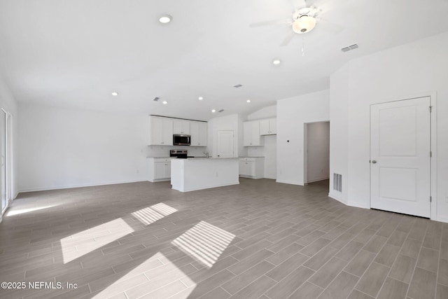 unfurnished living room with visible vents, recessed lighting, and wood tiled floor