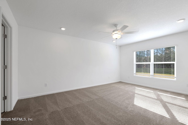 carpeted spare room featuring recessed lighting, baseboards, and ceiling fan