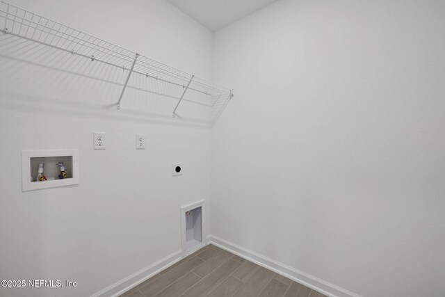 laundry area featuring baseboards, wood tiled floor, laundry area, hookup for a washing machine, and hookup for an electric dryer