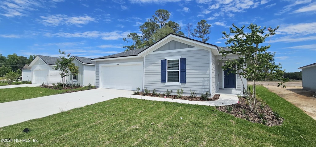 ranch-style house featuring a front yard and a garage