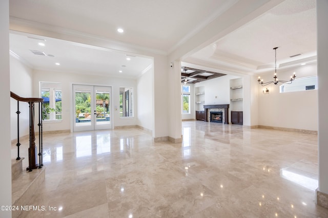 unfurnished living room with french doors, a fireplace, built in features, ornamental molding, and ceiling fan