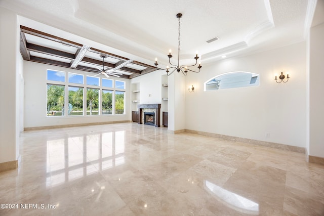 unfurnished living room featuring a raised ceiling, a fireplace, a textured ceiling, ornamental molding, and built in shelves