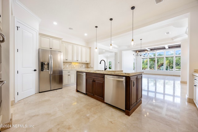 kitchen with pendant lighting, stainless steel appliances, tasteful backsplash, a center island with sink, and dark brown cabinets