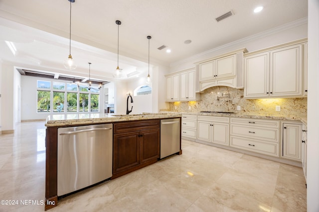 kitchen with appliances with stainless steel finishes, decorative backsplash, decorative light fixtures, cream cabinets, and sink