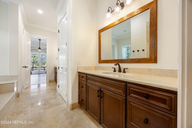 bathroom featuring vanity, ornamental molding, and french doors