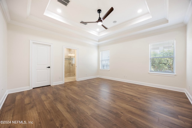 interior space with dark hardwood / wood-style flooring and a tray ceiling