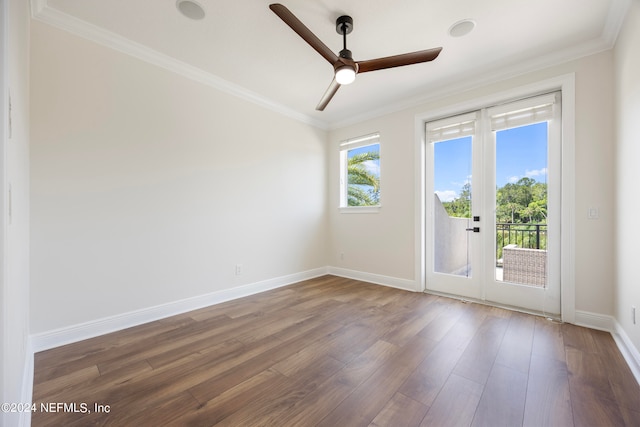 empty room featuring dark wood-type flooring, crown molding, french doors, and ceiling fan