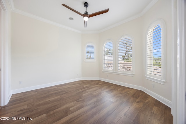 empty room with ceiling fan, dark wood-type flooring, and ornamental molding