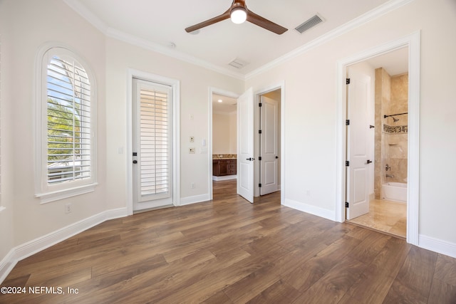 unfurnished bedroom with ceiling fan, crown molding, dark hardwood / wood-style floors, and ensuite bath