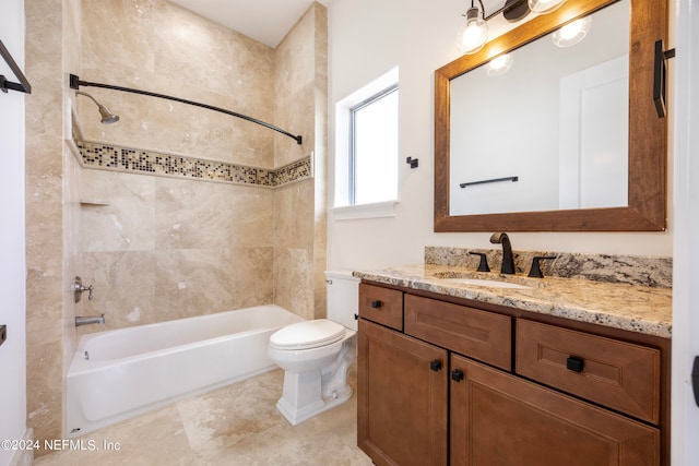 full bathroom featuring tiled shower / bath combo, vanity, and toilet