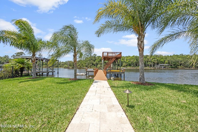 view of dock with a water view and a lawn