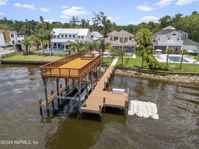 dock area with a water view and a yard