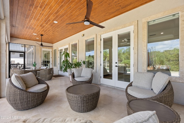 sunroom with ceiling fan and wooden ceiling