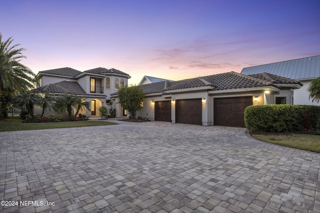 mediterranean / spanish home featuring a garage