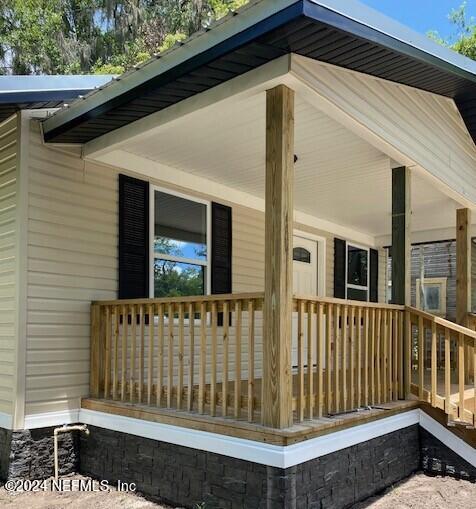 doorway to property with a porch