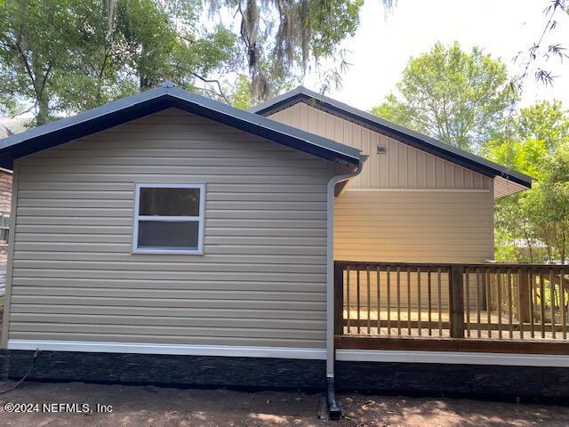 view of property exterior with a deck