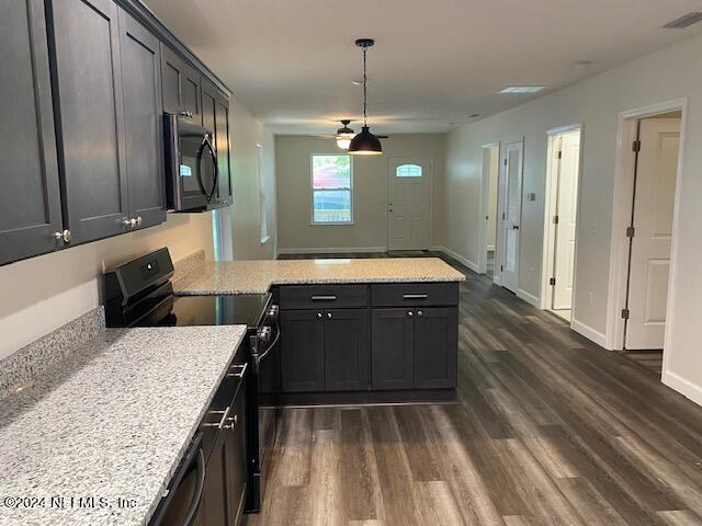 kitchen with decorative light fixtures, dark hardwood / wood-style flooring, kitchen peninsula, black range with electric stovetop, and light stone countertops