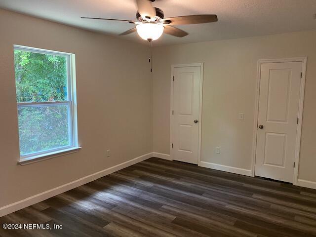 unfurnished room with ceiling fan and dark hardwood / wood-style floors