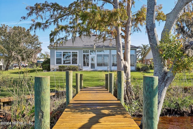 rear view of house with a yard