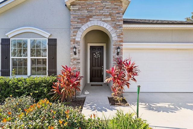 doorway to property with a garage