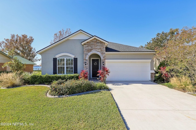 view of front facade with a front yard and a garage