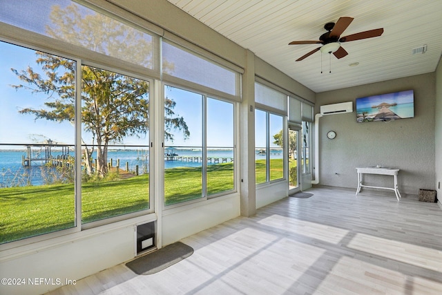 unfurnished sunroom with ceiling fan, wooden ceiling, and a wall unit AC